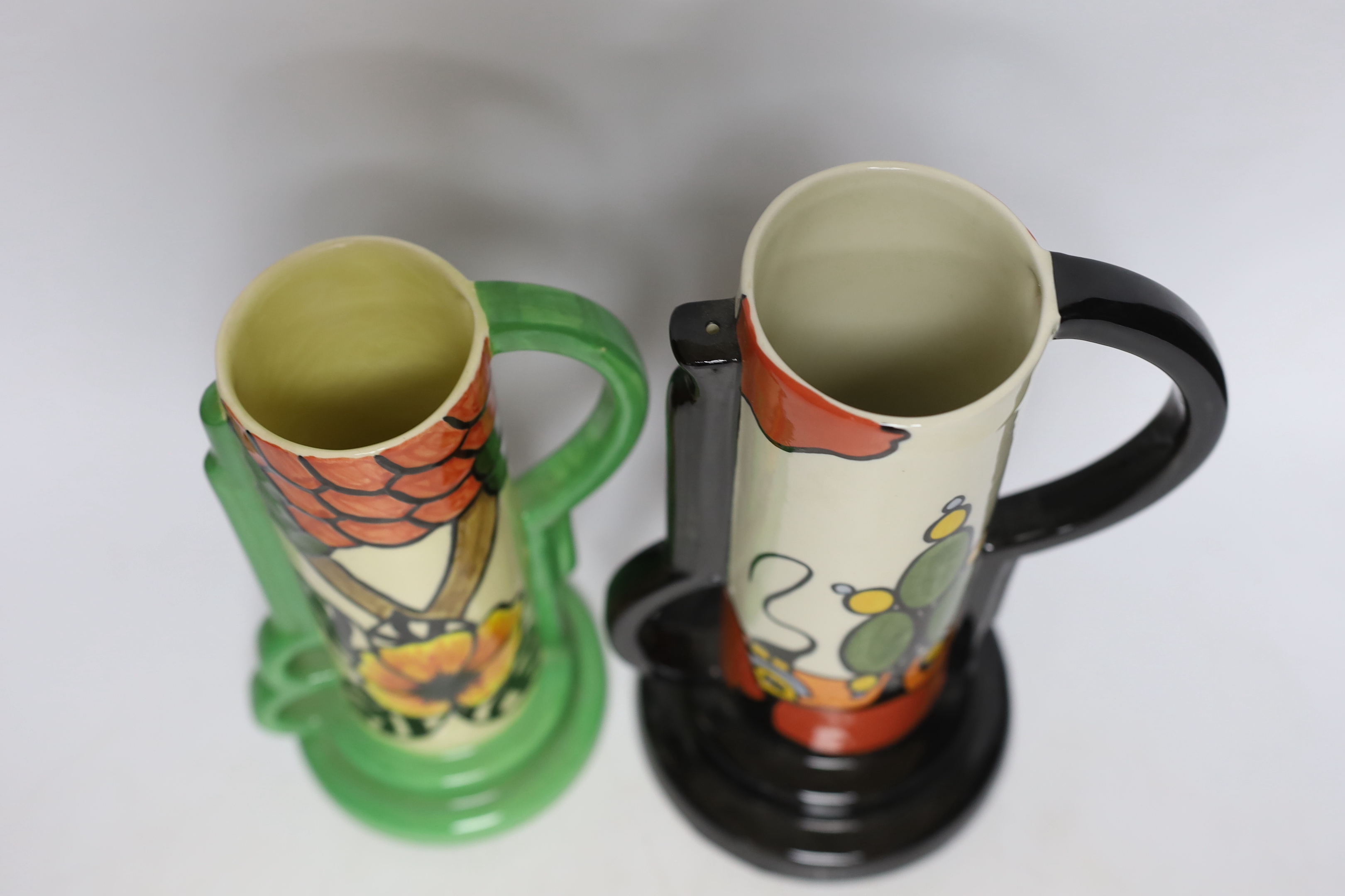 A Bernadette Eve “Orchard” jug, hand painted by Bernadette Eve and an Old Ellgreave “Marshland Cottage” jug, hand painted by Lorna Bailey, both in Clarice Cliff style, tallest 23.5cm